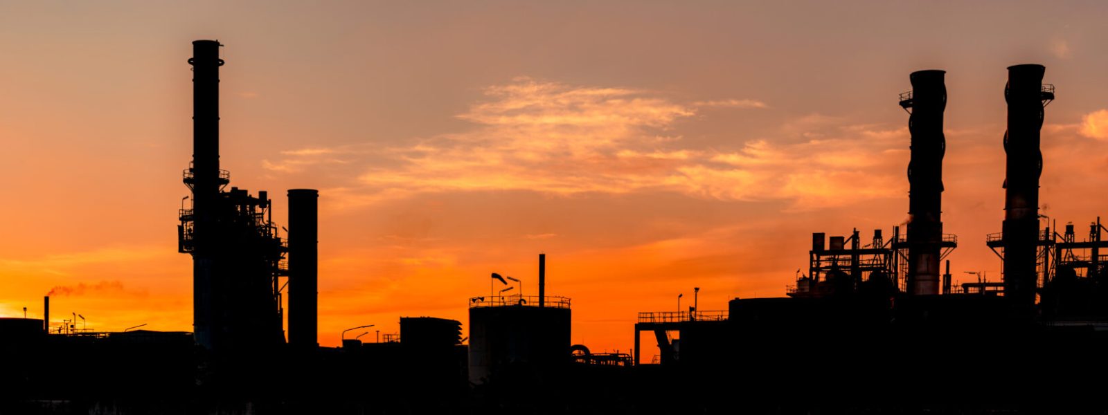 Gas turbine electrical power plant. Energy for support factory in industrial estate. Natural gas tank. Small gas power plant. Power plant using natural gas for fuel. Green energy. Dramatic sunset sky.